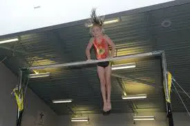 Gymnast in front support on bars