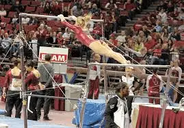 gymnast jump to high bar in level 6 bar routine