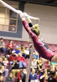 gymnast on high bar in Xcel platinum bars