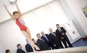 Xcel beam gymnast standing