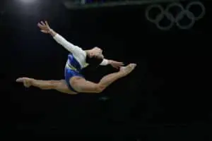 Gymnast doing ring leap on Xcel Diamond floor
