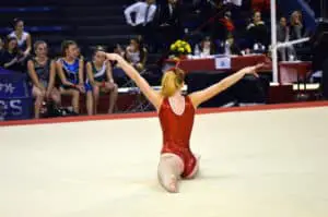 gymnast doing split in xcel floor