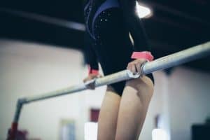 gymnast in support during Level 3 bar routine